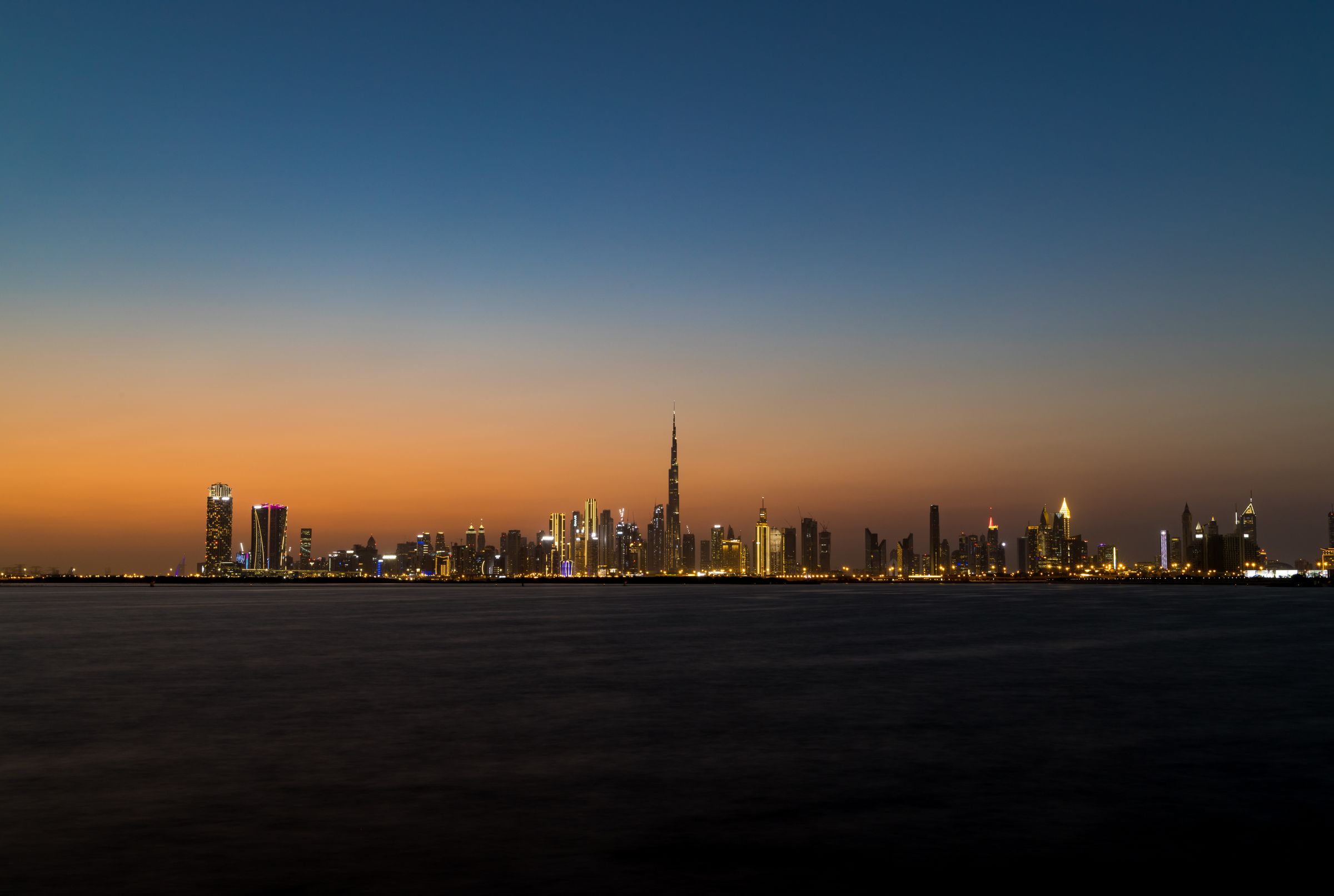 Dubai skyline at twilight seen across the water