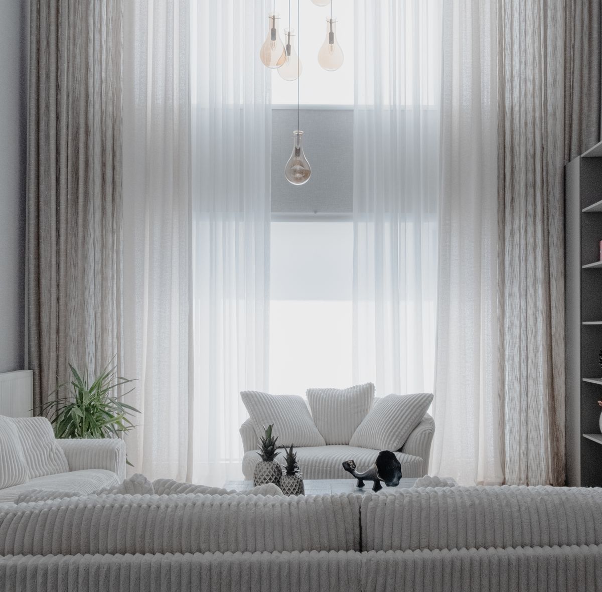 Bright modern living room with white sofas